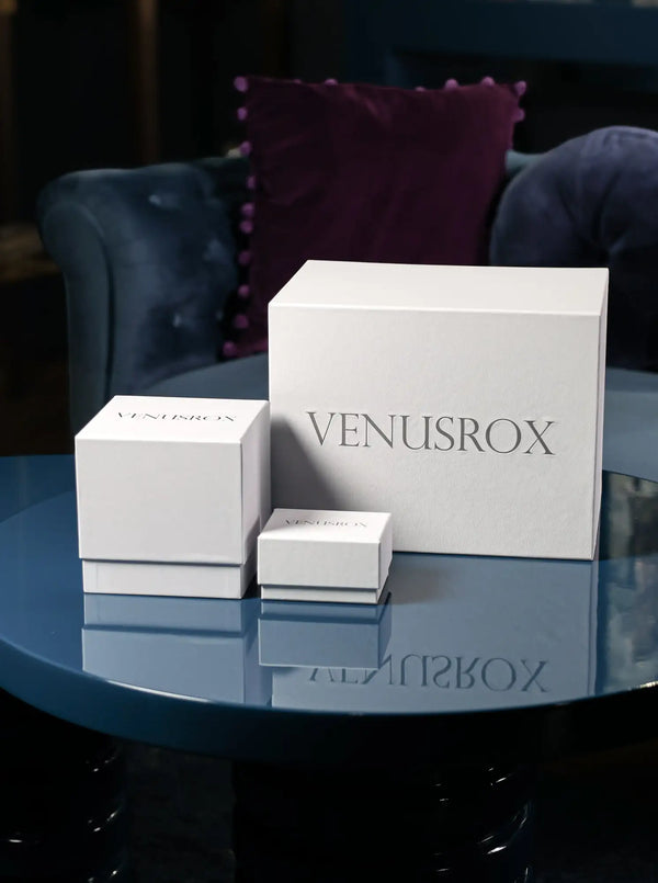 Three white rectangular boxes with the brand name ’venusrox’ printed in a sleek, dark gray font on each side.